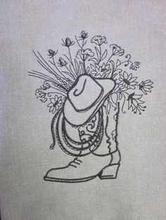 a drawing of a cowboy boot with flowers in it's hat on a piece of paper