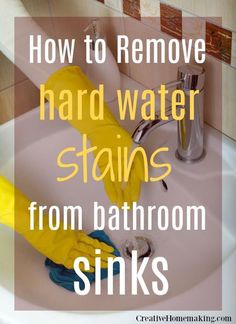 a sink with yellow gloves on it and the words how to remove hard water stains from bathroom sinks