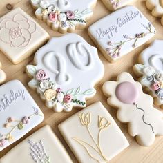 decorated cookies are arranged on a table for someone to decorate their birthdays or special occasions