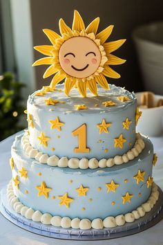 a blue cake with yellow stars and a smiling sun on top