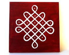 a red and white painting on wood with an intricate design in the middle, against a white background