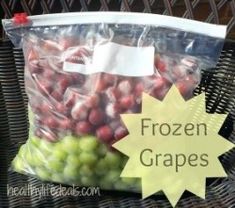 a bag filled with frozen grapes sitting on top of a wicker table next to a basket