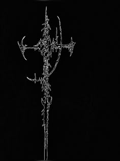 a cross with barbed wire on it in the dark