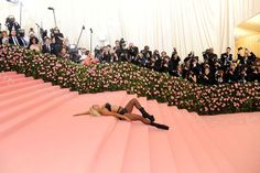 a woman laying on top of a pink carpet