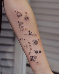 a person with a tattoo on their arm that has many different things in the sky