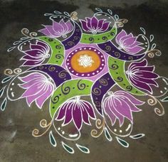 a colorful flower design is painted on the ground with white and purple flowers in the center