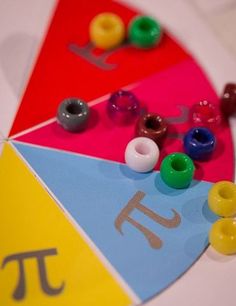 a close up of a colorful wheel of fortune with beads on the side and numbers in the middle