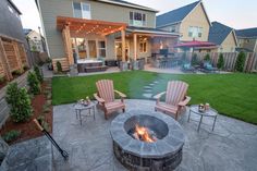 an outdoor fire pit surrounded by lawn furniture