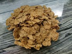 a pile of cereal sitting on top of a wooden table