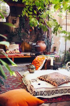 a living room filled with lots of furniture and plants on top of it's floor