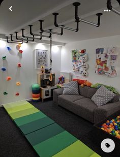 a play room with toys and games on the walls, carpeted flooring and colorful rugs