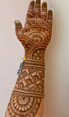 the hand is decorated with intricate designs