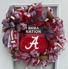 a wreath that has the letter a on it and is decorated with footballs, mesh netting