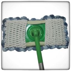 a close up of a mop with a green handle