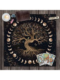 the tree of life is surrounded by moon phases and taroti cards on a wooden table