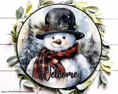 a snowman with a hat and scarf on it's face is painted in watercolor