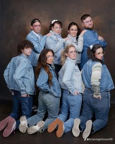 a group of people standing next to each other posing for a photo with their arms around one another