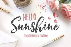 the hello sunshine font is displayed on a white surface with pink flowers and crochet