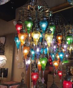 an assortment of colorful lights hanging from a chandelier in a room with other items