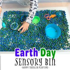 an earth day activity for toddlers to play in the sand and water with their hands