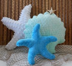 two starfish pillows sitting next to each other