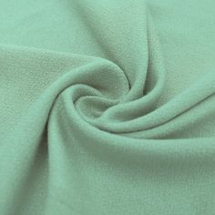 a close up shot of the fabric in mint green color, with very soft folds