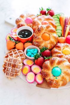 a platter filled with lots of different types of food on top of a table