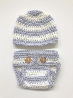 two crocheted hats with buttons on them