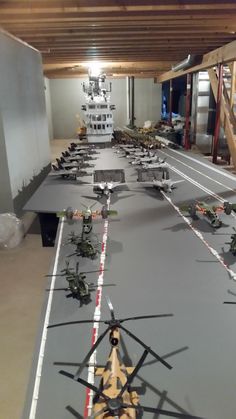 a long table with many model airplanes on it