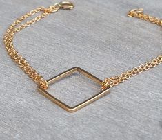 A delicate gold square bracelet, 14k goldfilled chain doubles on each side of a 14k goldfilled square pendant. This is your perfect gold jewelry for everyday wear. The bracelet measures 7 inches. The 14K gold filled square pendant measures 0.6 inch / 1.5 cm. Please take a minute to check out my other modern bracelets: http://www.etsy.com/shop/HLcollection?section_id=12318419 All jewelry ships individually gift wrapped in a box with a bow. perfect for giving or treating yourself! ♥ ♥ ♥ ♥ ♥ ♥ ♥ ♥ Minimalist Square Jewelry With Adjustable Chain, Adjustable Gold Cube Jewelry, Adjustable Square Gold Bracelet, Minimalist 14k Gold Bracelet With Rectangular Shape, Dainty Gold Square Jewelry, Square Gold Minimalist Jewelry, Minimalist Square Gold Jewelry, Gold Square Bracelets As Gift, Gold Square Bracelets For Gift