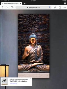 a buddha statue sitting on top of a wooden table next to a lamp and wall