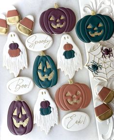 decorated halloween cookies are displayed on a table