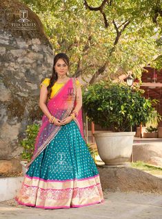 a woman in a blue and pink lehenga