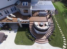 an aerial view of a large house with decking and patio furniture in the yard