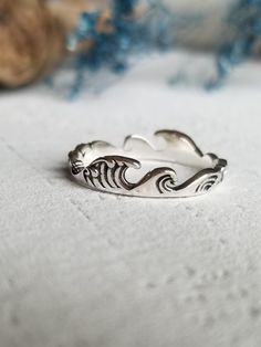 This wave ring is made from 925 sterling silver (hypoallergenic) and is a wonderful gift for ocean lovers!  You can choose your size.  Enjoy free shipping and it will come in a box ready to gift! Minimalist Silver Rings For The Beach, Silver Ocean-inspired Jewelry For Promise Ring, Ocean-inspired Sterling Silver Rings, Ocean-inspired Silver Rings For The Beach, Silver Ocean-inspired Promise Ring, Adjustable Wavy Rings As A Gift, Minimalist Sterling Silver Jewelry For Beach, Wavy Sterling Silver Beach Jewelry, Adjustable Silver Rings With Ocean-inspired Style