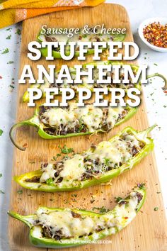 stuffed anaheim peppers on a cutting board with cheese and seasoning next to them,