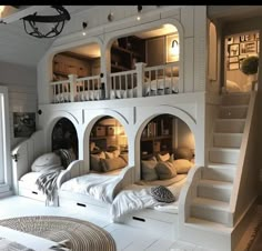 a room with bunk beds in it and stairs leading up to the second floor area