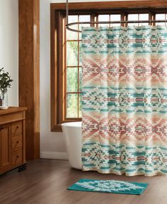 a bath room with a toilet and a shower curtain