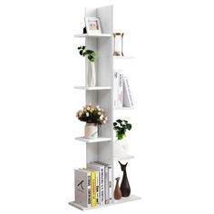 a white book shelf filled with books and vases