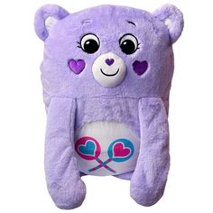 a purple teddy bear with hearts on its chest