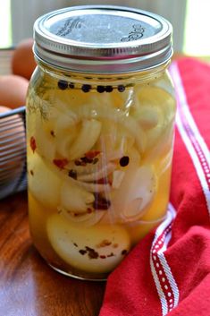 a jar filled with pickled onions on top of a table