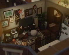 an aerial view of a living room and kitchen from the second floor looking down at the dining area