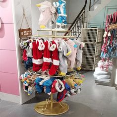 a display in a store filled with lots of baby clothes and hats hanging from hooks