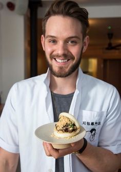 a man holding a plate with food on it