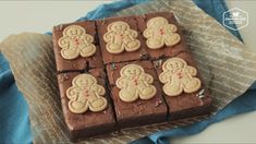 some brownies with icing and gingerbreads on top of each other in the shape of men