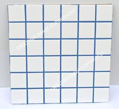 a white and blue tile with squares on it