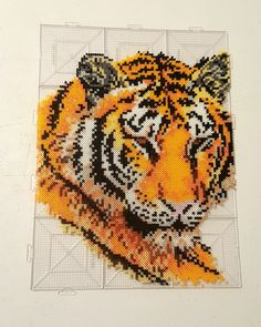 a cross stitch picture of a tiger