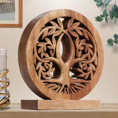 a wooden clock sitting on top of a table next to a vase and candle holder