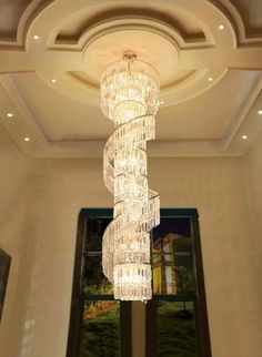 a large crystal chandelier hanging from the ceiling in a room with high ceilings