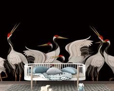 a baby crib in front of a wall with three cranes on it's sides